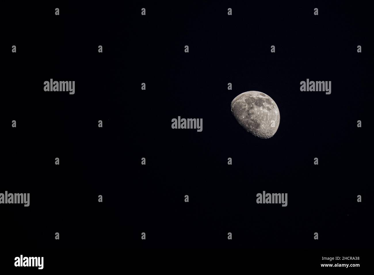 Gibbous moon against a black night sky Stock Photo