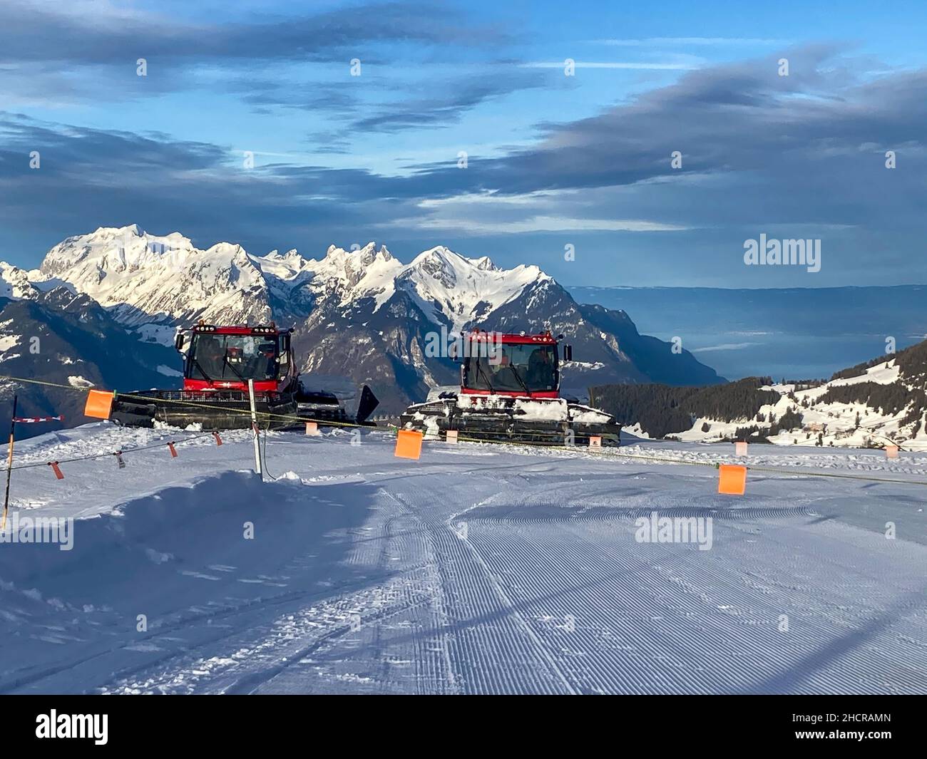 Villars sur Ollon, Switzerland - 04. February 2021: Two Pistenbully in the Mountain Landscape after preparing the Slopes Stock Photo