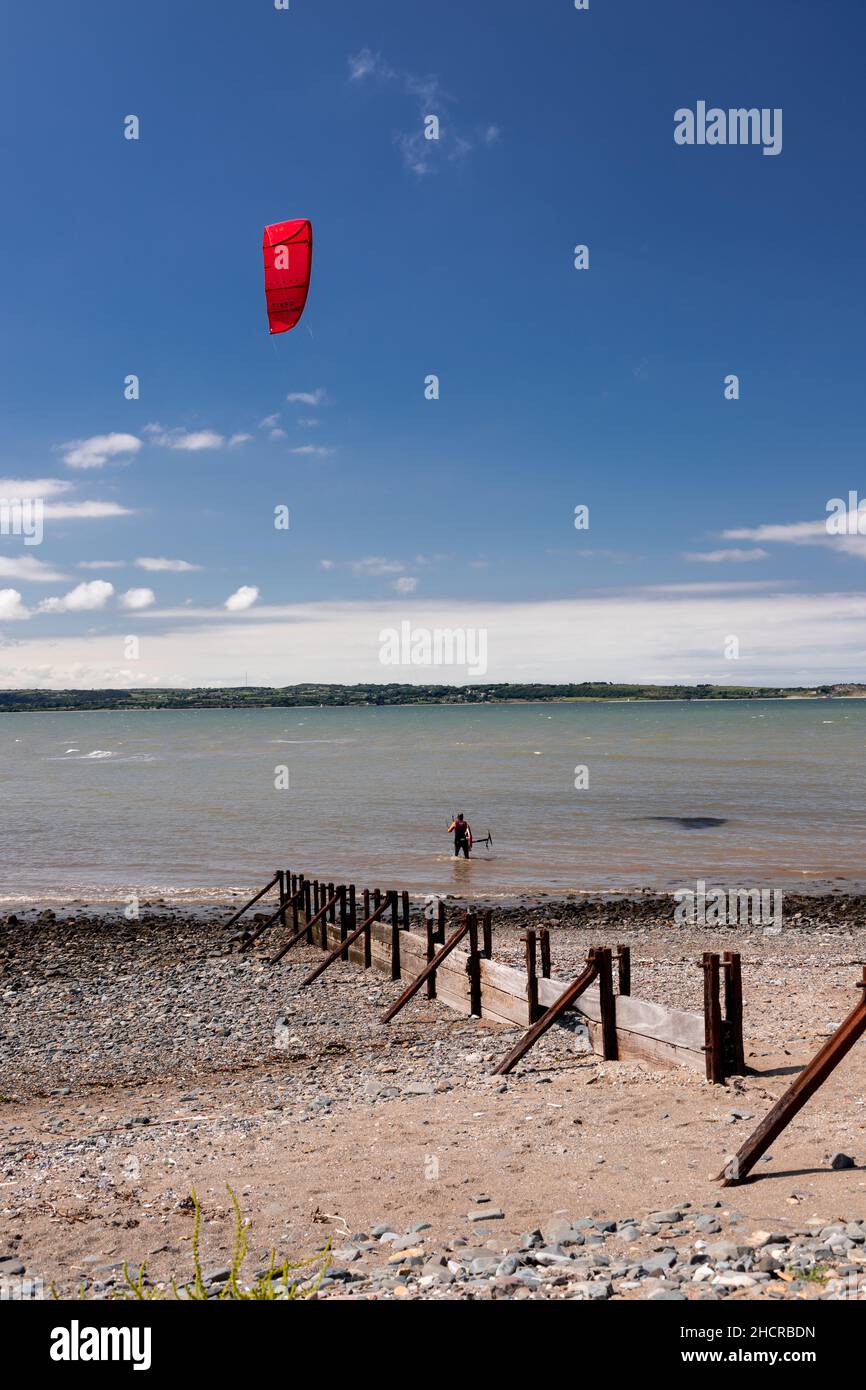Kite surfer on the beach at Llanfairfechan, North Wales Stock Photo