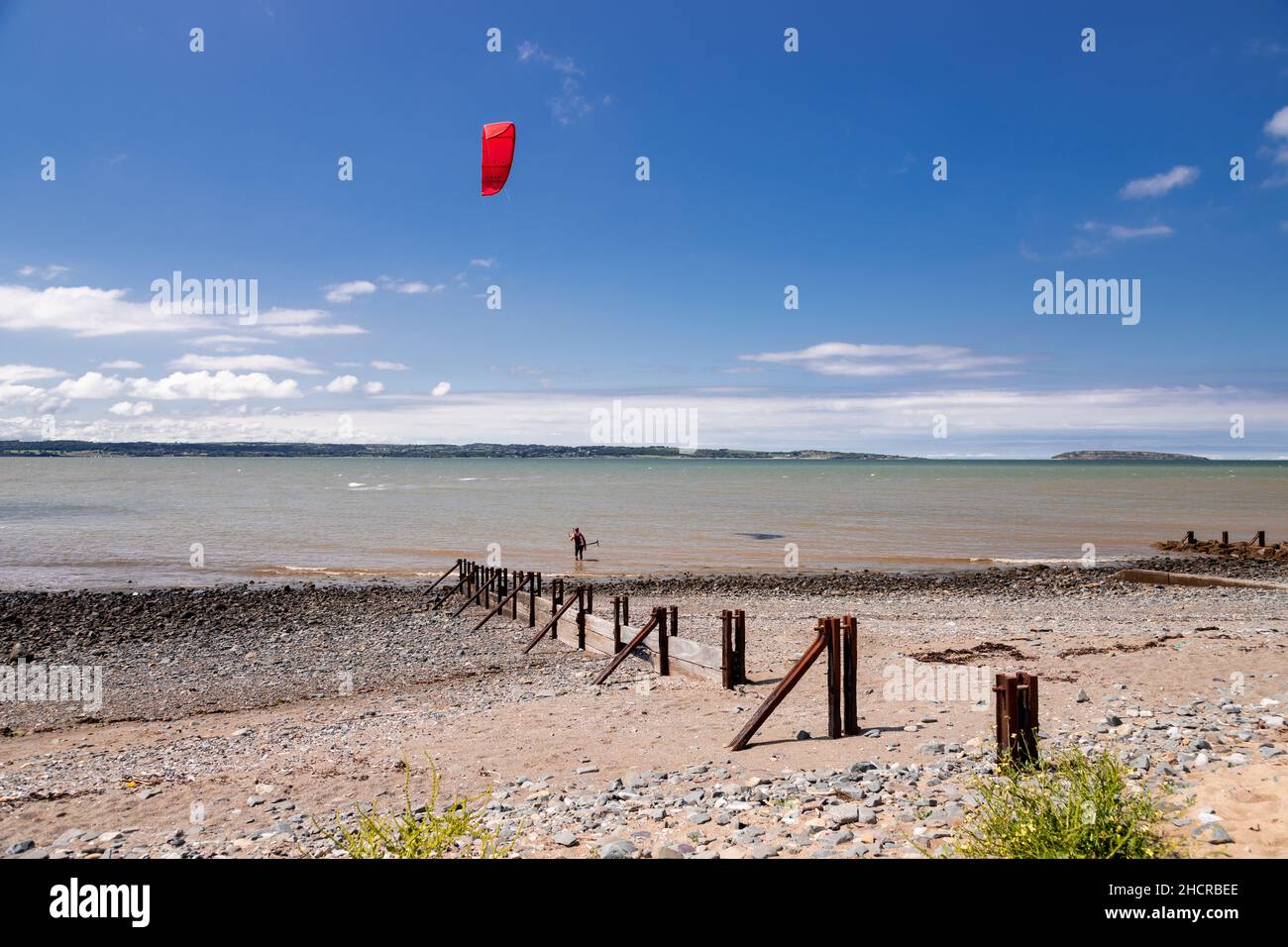 Kite surfer on the beach at Llanfairfechan, North Wales Stock Photo