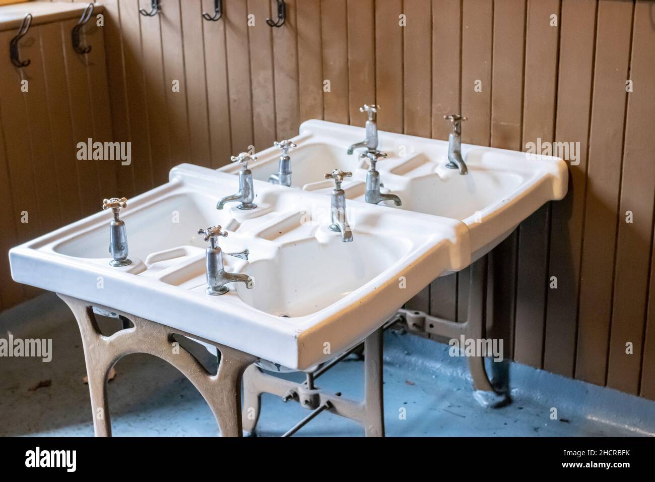 a set of ceramic children's basins or sinks in a primary school cloakroom at Beamish Village Stock Photo