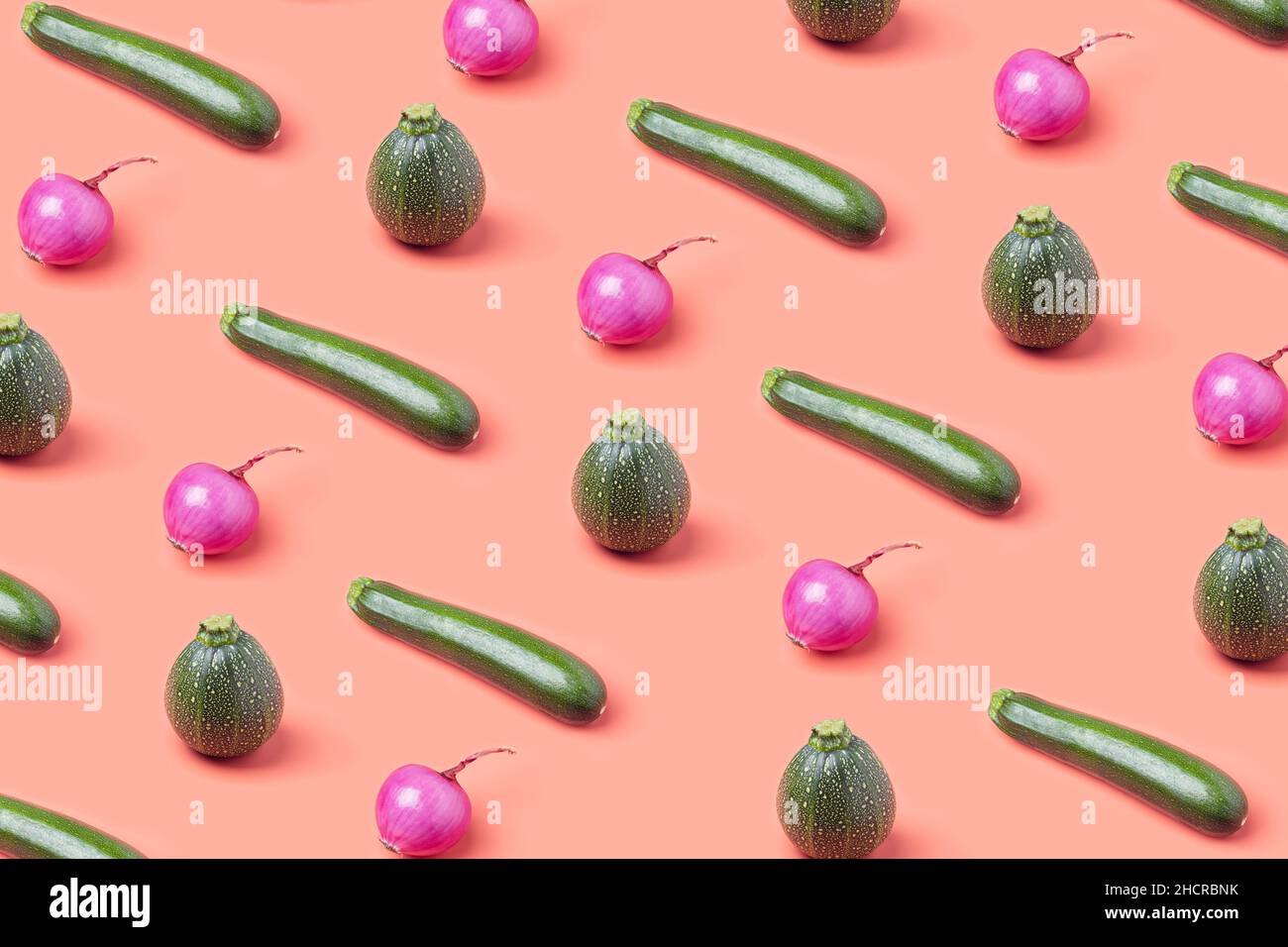 Various fresh vegetables layout on a pastel pink background. Minimal vegan diet pattern Stock Photo