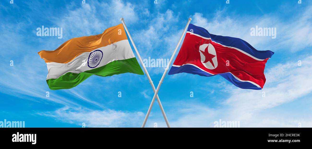 crossed national flags of India and North Korea flag waving in the wind ...