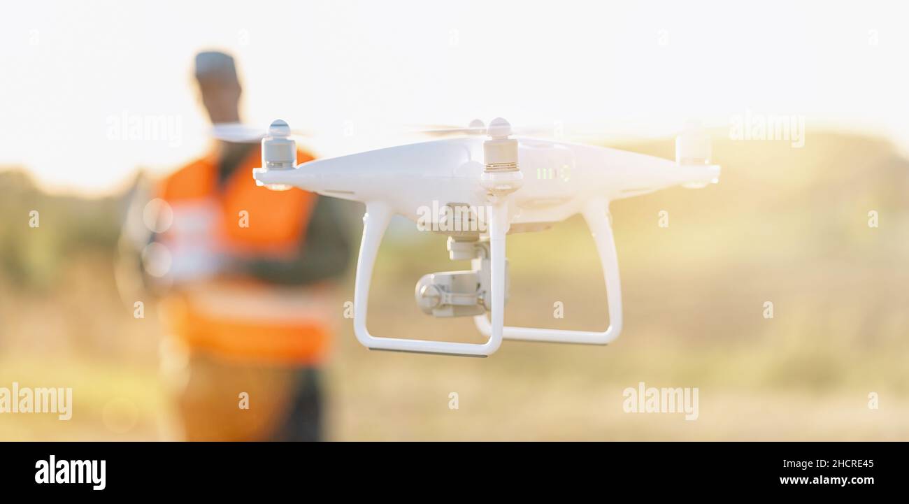 Drone operated by construction worker on building site Stock Photo