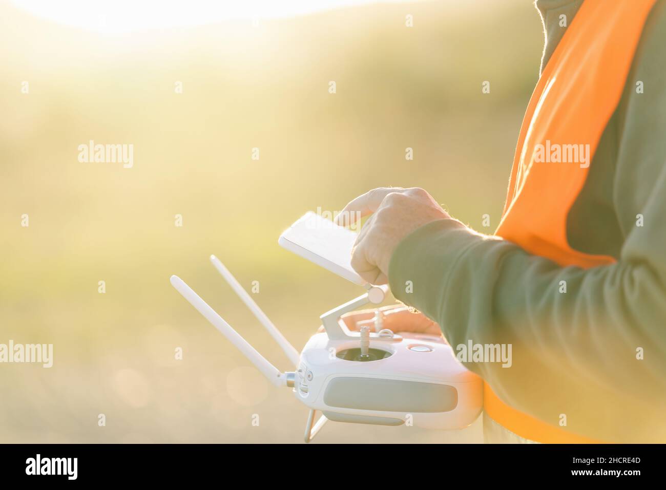 Drone operated by construction worker on building site use touchscreen Stock Photo