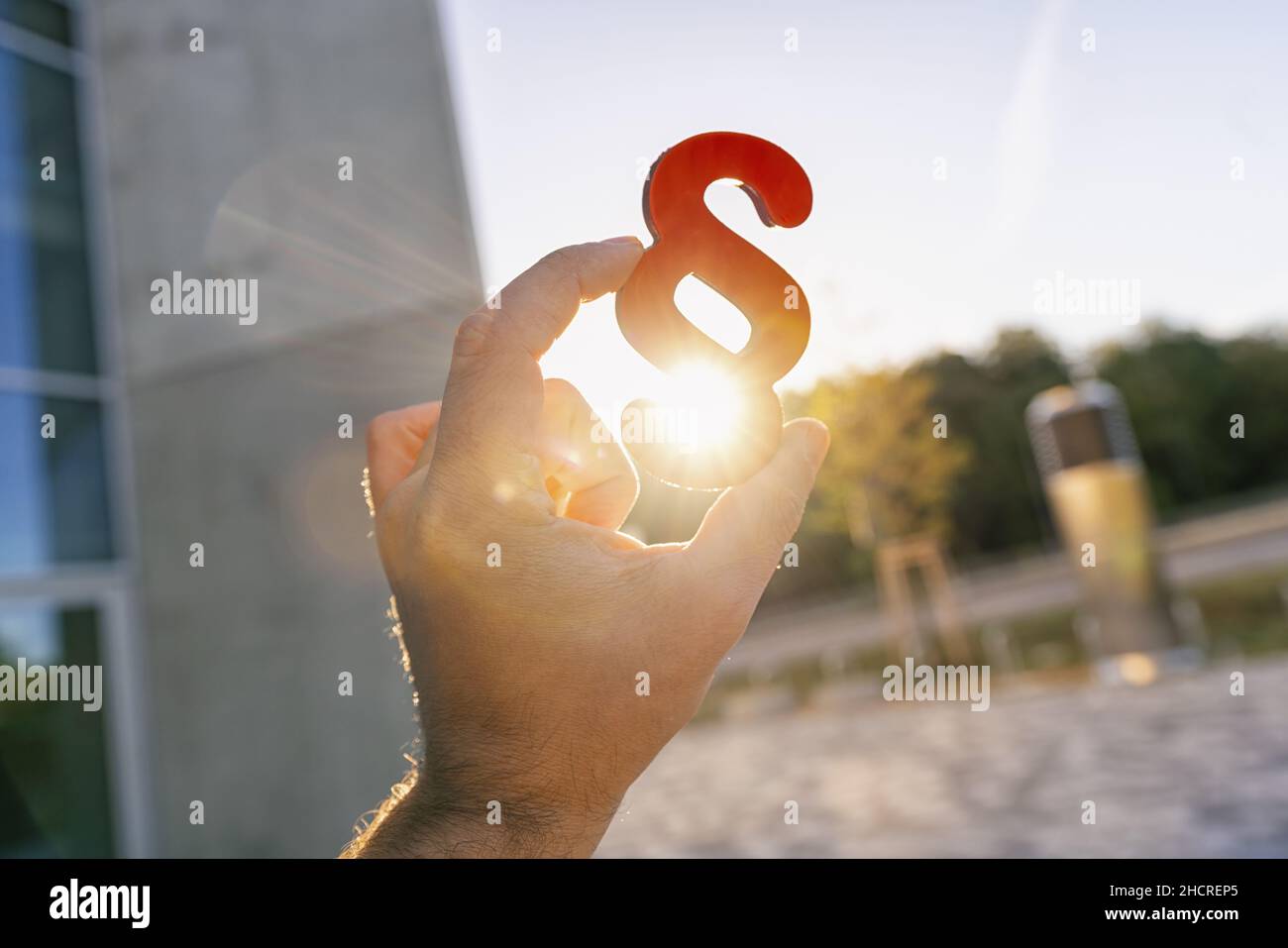 Hand holds paragraph in to the sun Stock Photo