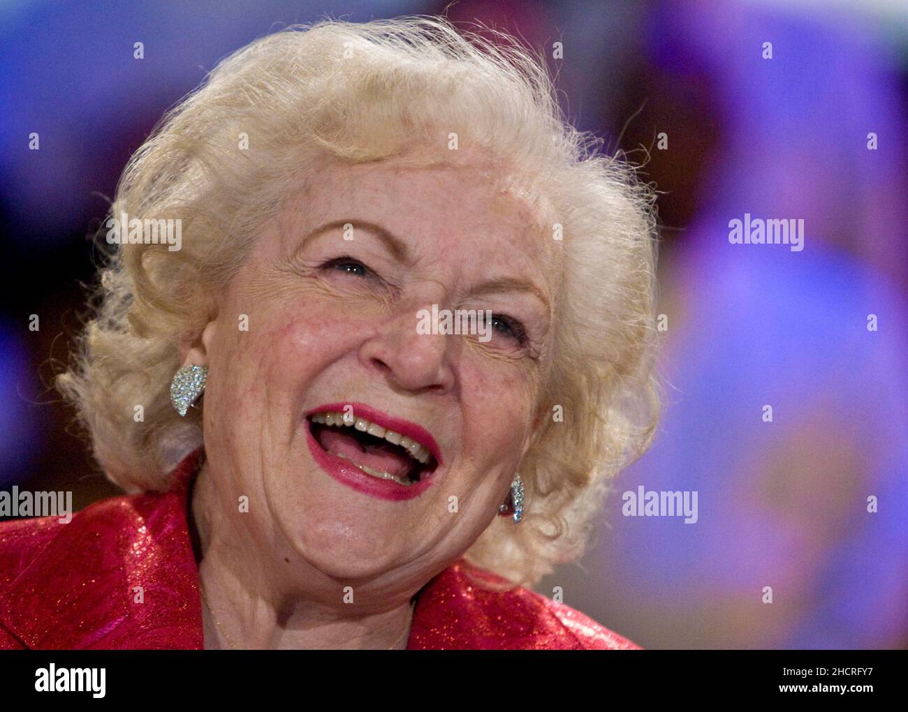 Actress Betty White smiles after the Hallmark Gospel Choir sang for her