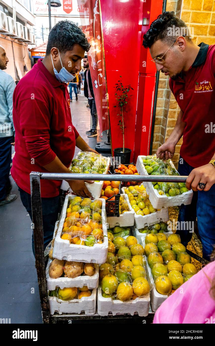 Two Young Men Delivering Fruit To A Restaurant In Downtown Amman, Amman, Jordan. Stock Photo