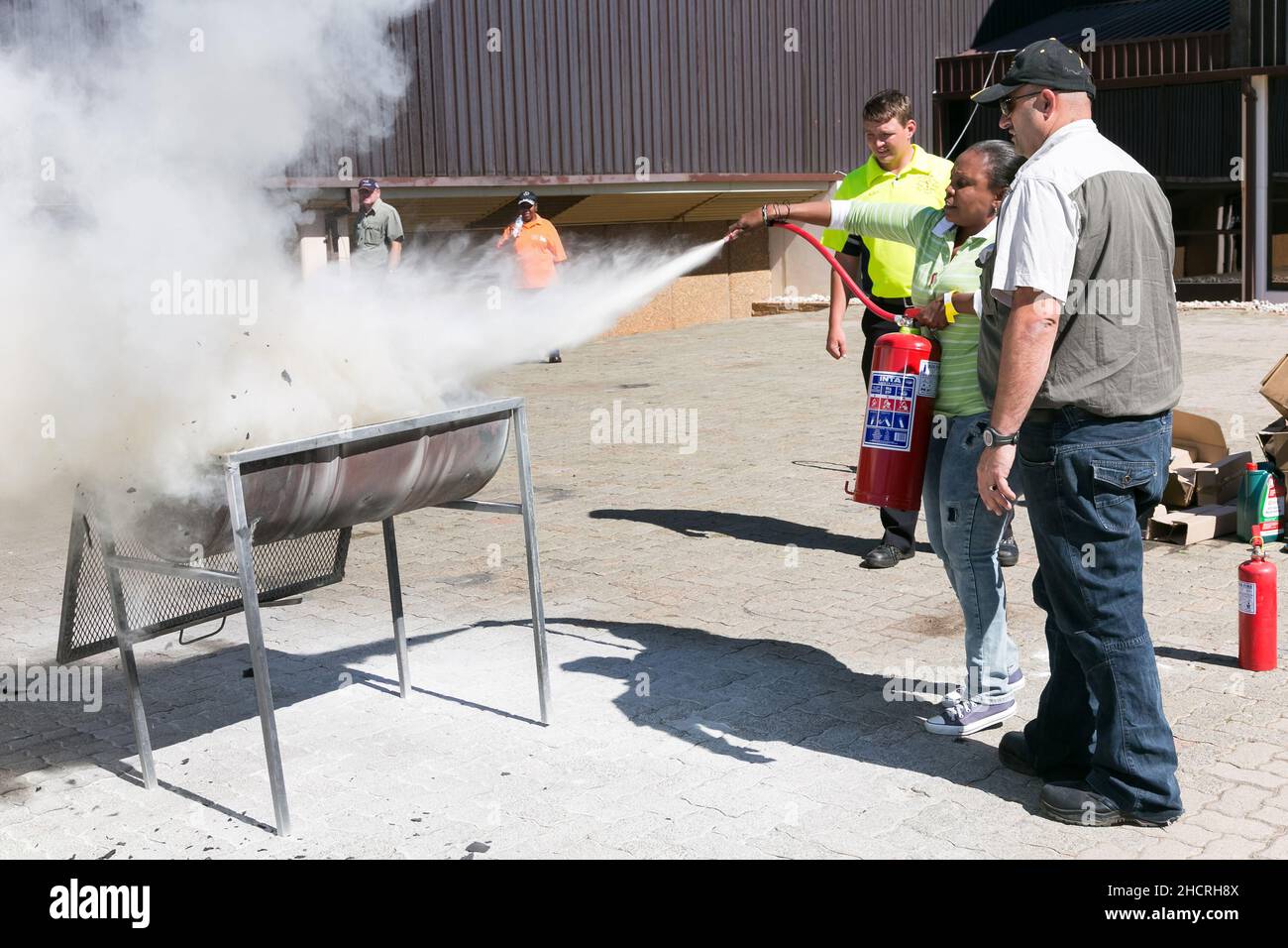 Process of fire hazard training with a powder-based extinguisher Stock Photo