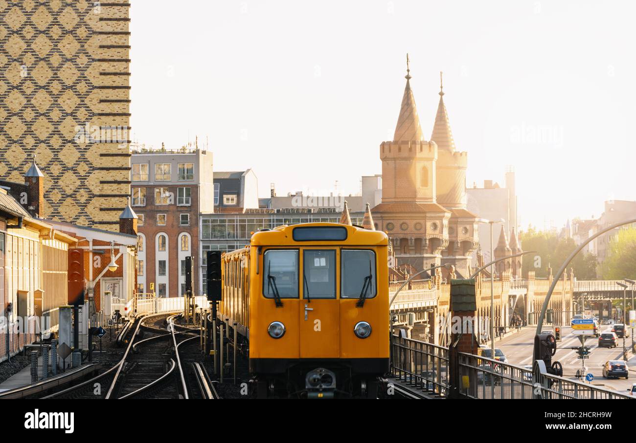 Berliner U-Bahn with Oberbaum Bridge in the background in golden evening light at sunset, , Capital of Germany Stock Photo