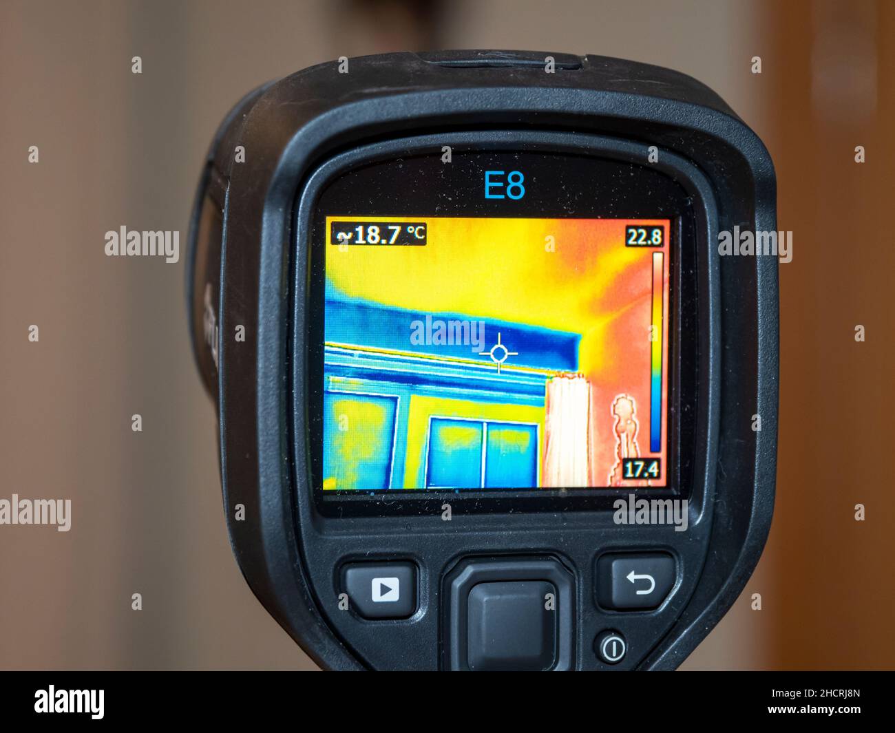 A thermal imaging camera being used to assess heat loss from a house