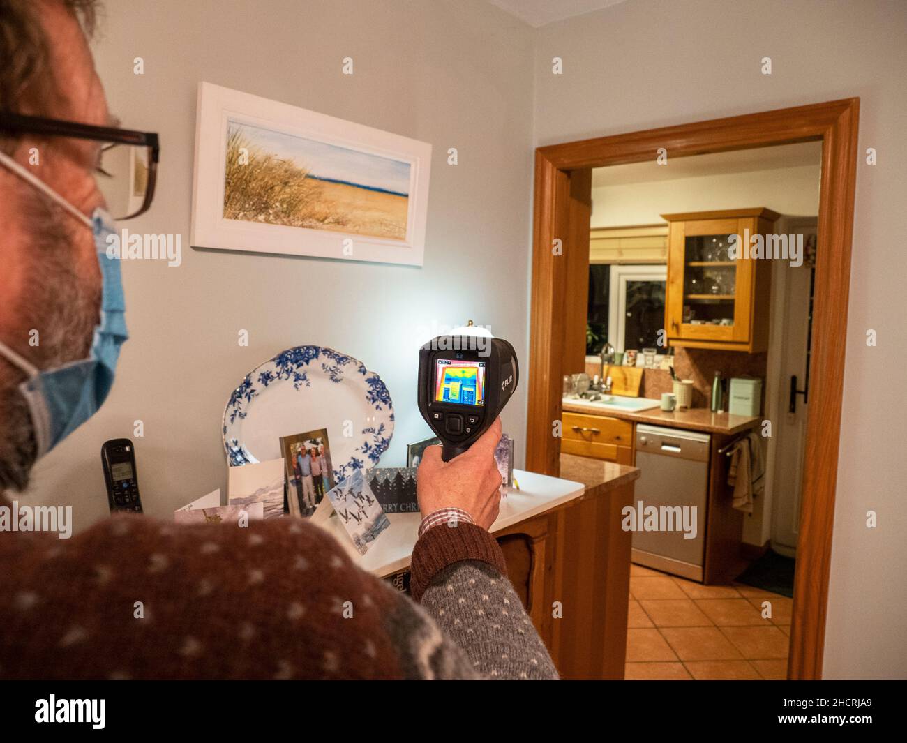 A thermal imaging camera being used to assess heat loss from a house Stock Photo Alamy