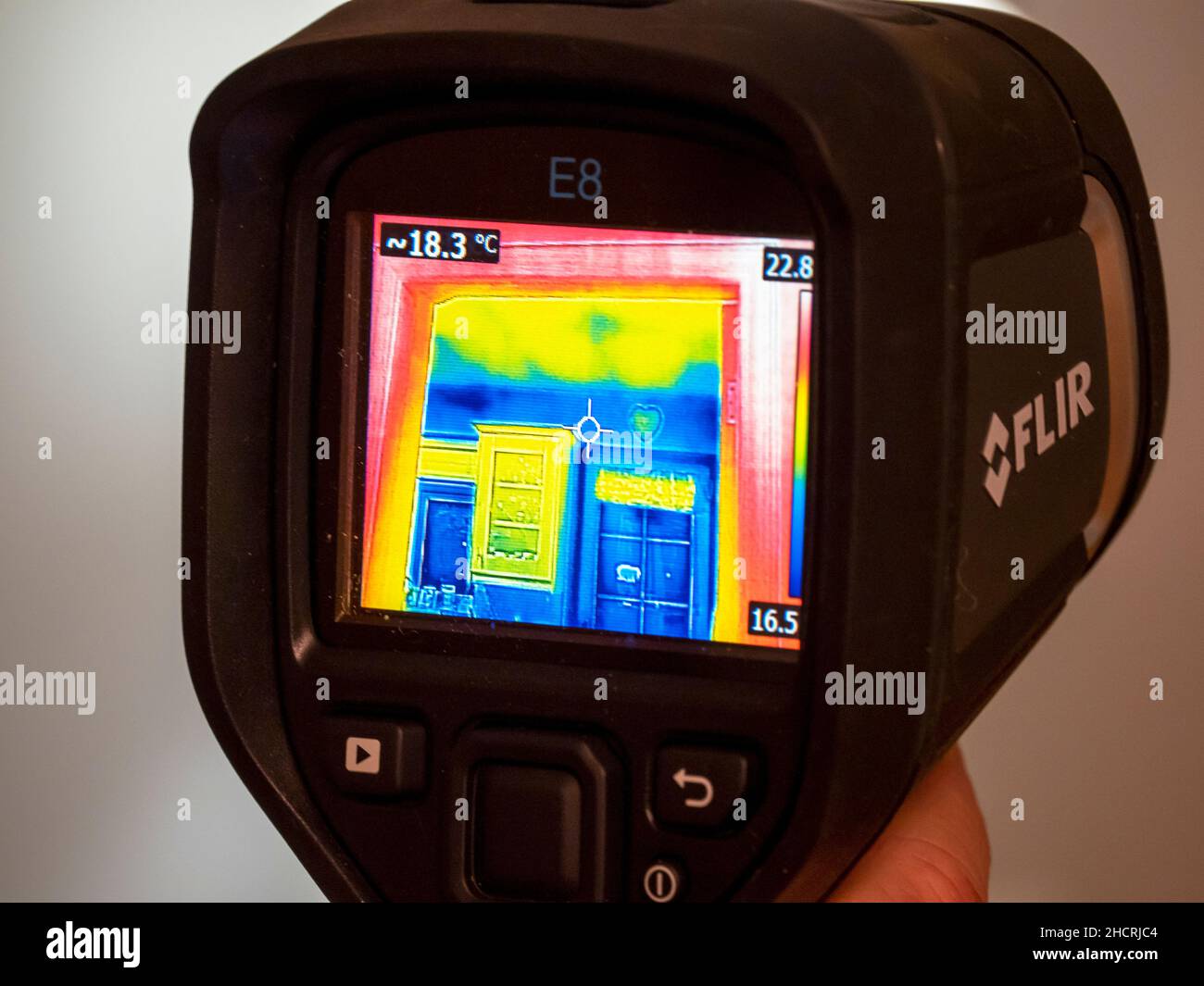 A thermal imaging camera being used to assess heat loss from a house
