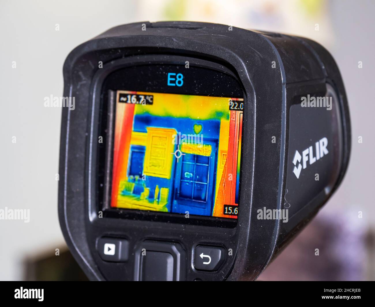 A thermal imaging camera being used to assess heat loss from a house
