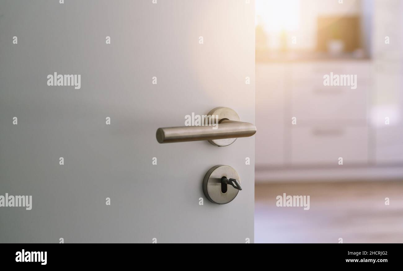 opened white door to modern kitchen interior as background Stock Photo