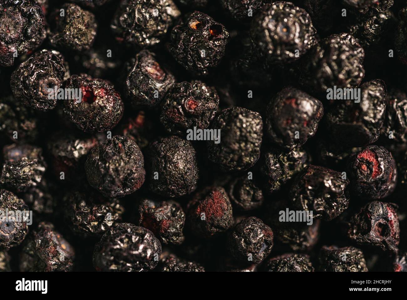 Heap of dried Chokeberries for use as background image or as texture Stock Photo