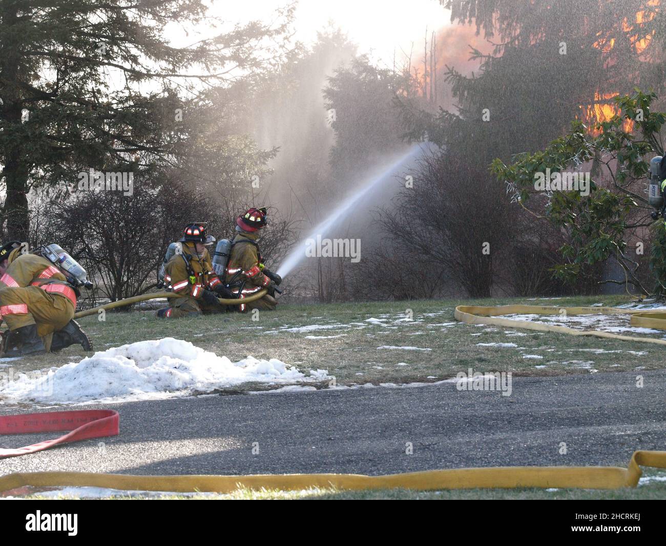 Firefighter at working fire with dramatic flames Stock Photo - Alamy