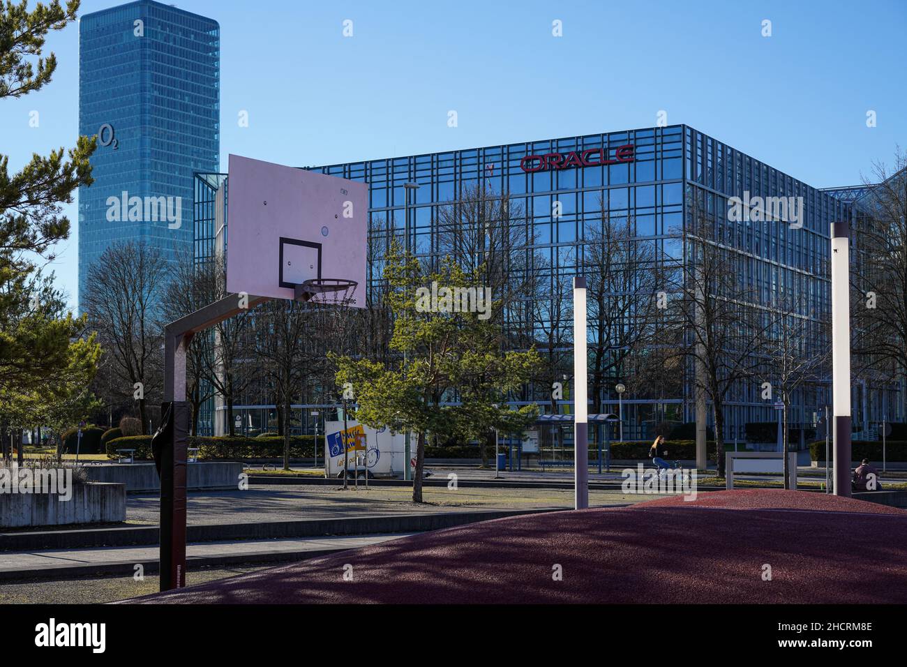 A basketball court. Behind it the headquarters of Oracle in Munich and the O2 skyscraper. Stock Photo