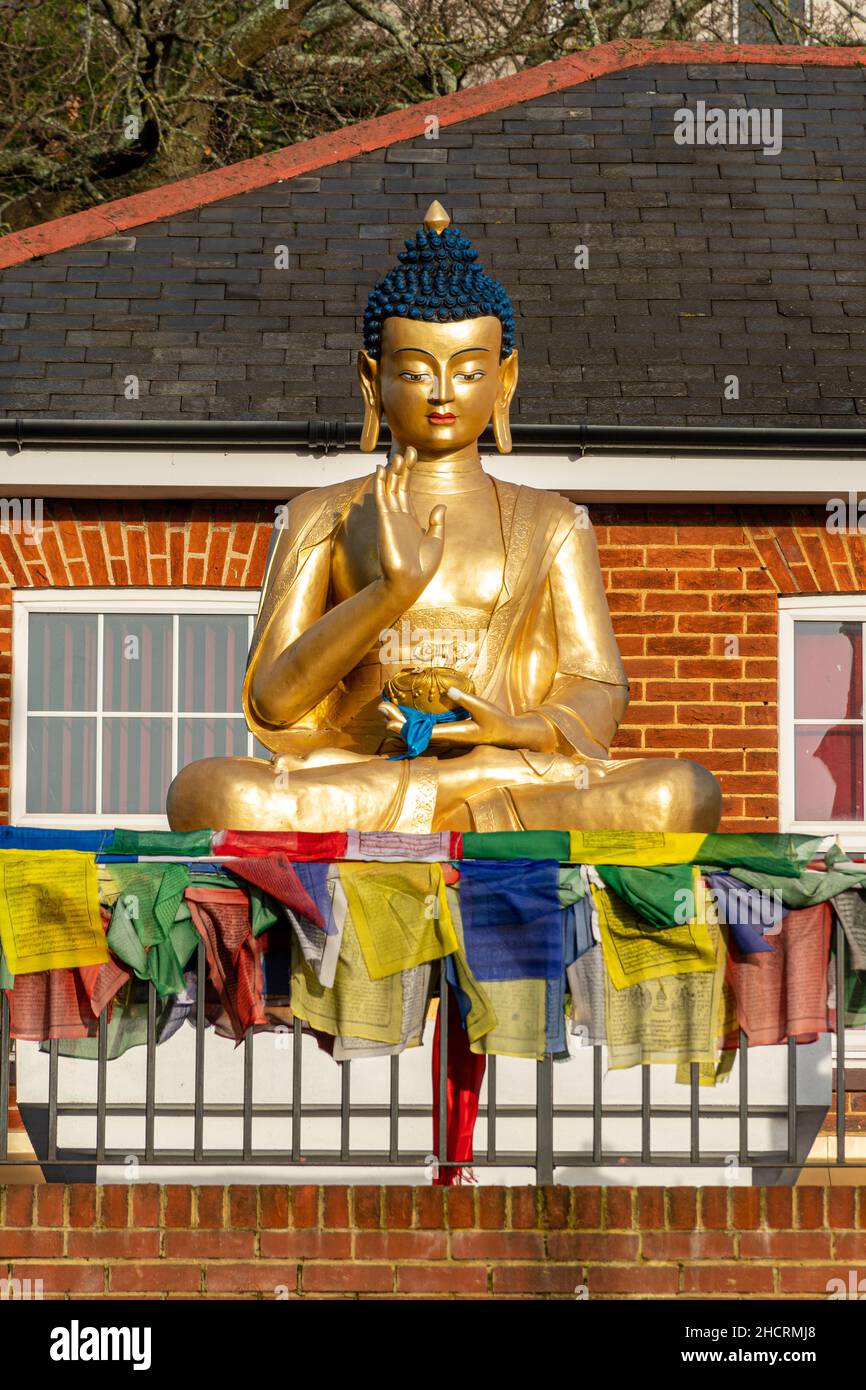 The Buddhist Community Centre in Aldershot, Hampshire, England, UK. A Buddha statue outside the building. Stock Photo