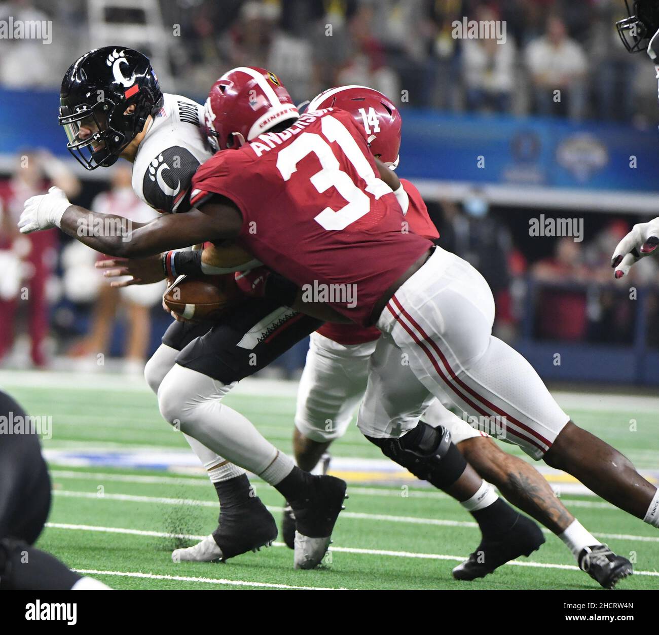 Arlington, USA. 31st Dec, 2021. The Alabama defense sacks Cincinnati quareterback Bryce Young in the 2021 Cotton Bowl Classic, one of the College Football Playoff Semifinal games, on Friday, December 31, 2021 at AT&T Stadium in Arlington, Texas. The Tide won 27-6 and will play for the national championship on January 10, 2022. Photo by Ian Halperin/UPI Credit: UPI/Alamy Live News Stock Photo