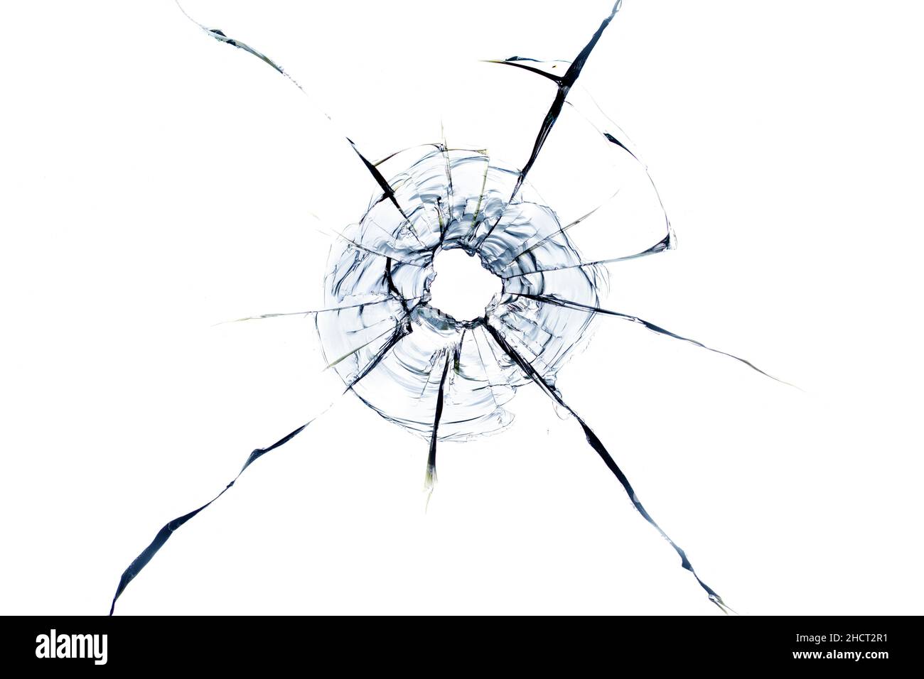 Cracks in the glass from the bullet. Abstract background. Damaged glass.  Cracks on a white background Stock Photo - Alamy