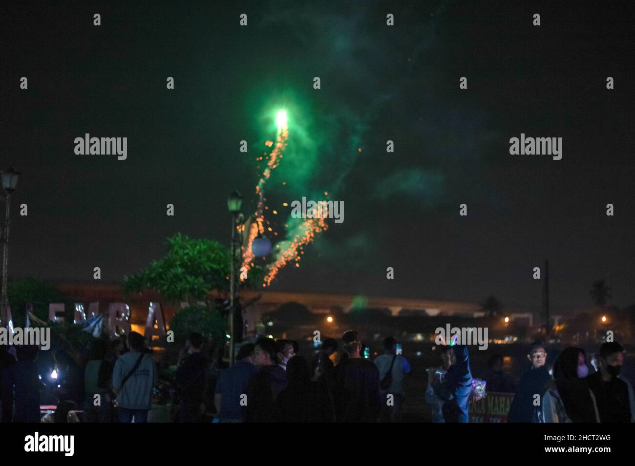 Palembang, South Sumatra, Indonesia. 1st Jan, 2022. A group of people are watching fireworks in the courtyard of Kuto Besak Fort. (Credit Image: © Muhammad Shahab/Pacific Press via ZUMA Press Wire) Credit: ZUMA Press, Inc./Alamy Live News Stock Photo