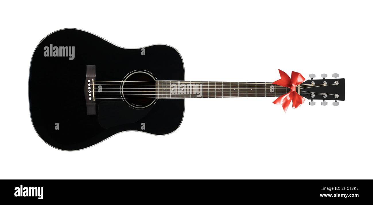 Musical instrument Black acoustic guitar a red bow isolated on a