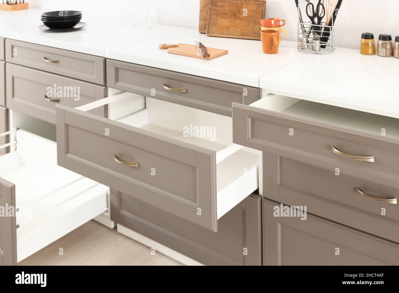 Opened kitchen drawers and utensils in room Stock Photo Alamy