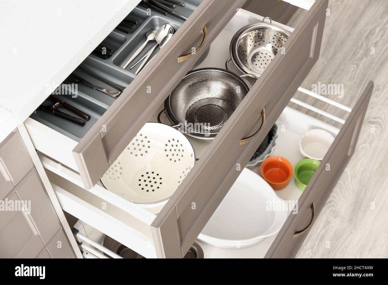 Set of kitchenware in open drawers, closeup Stock Photo - Alamy