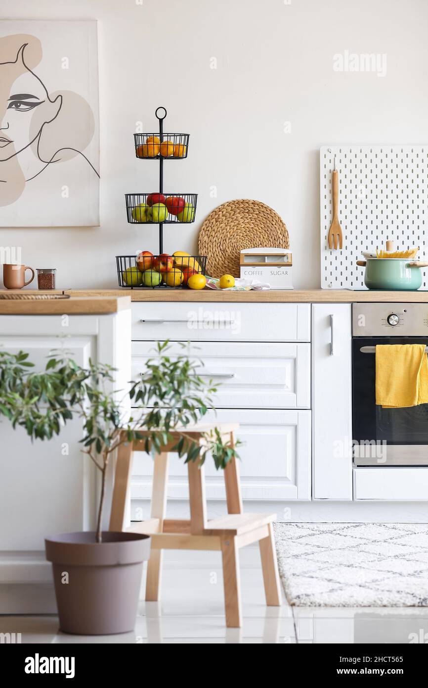 Interior of light modern kitchen with white counters and healthy food ...
