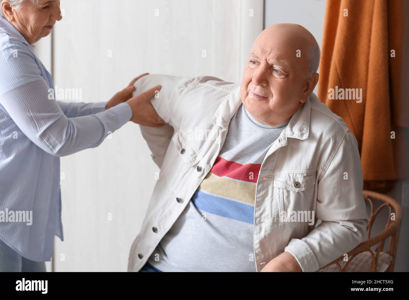 Senior man suffering from back pain and his wife at home Stock Photo ...