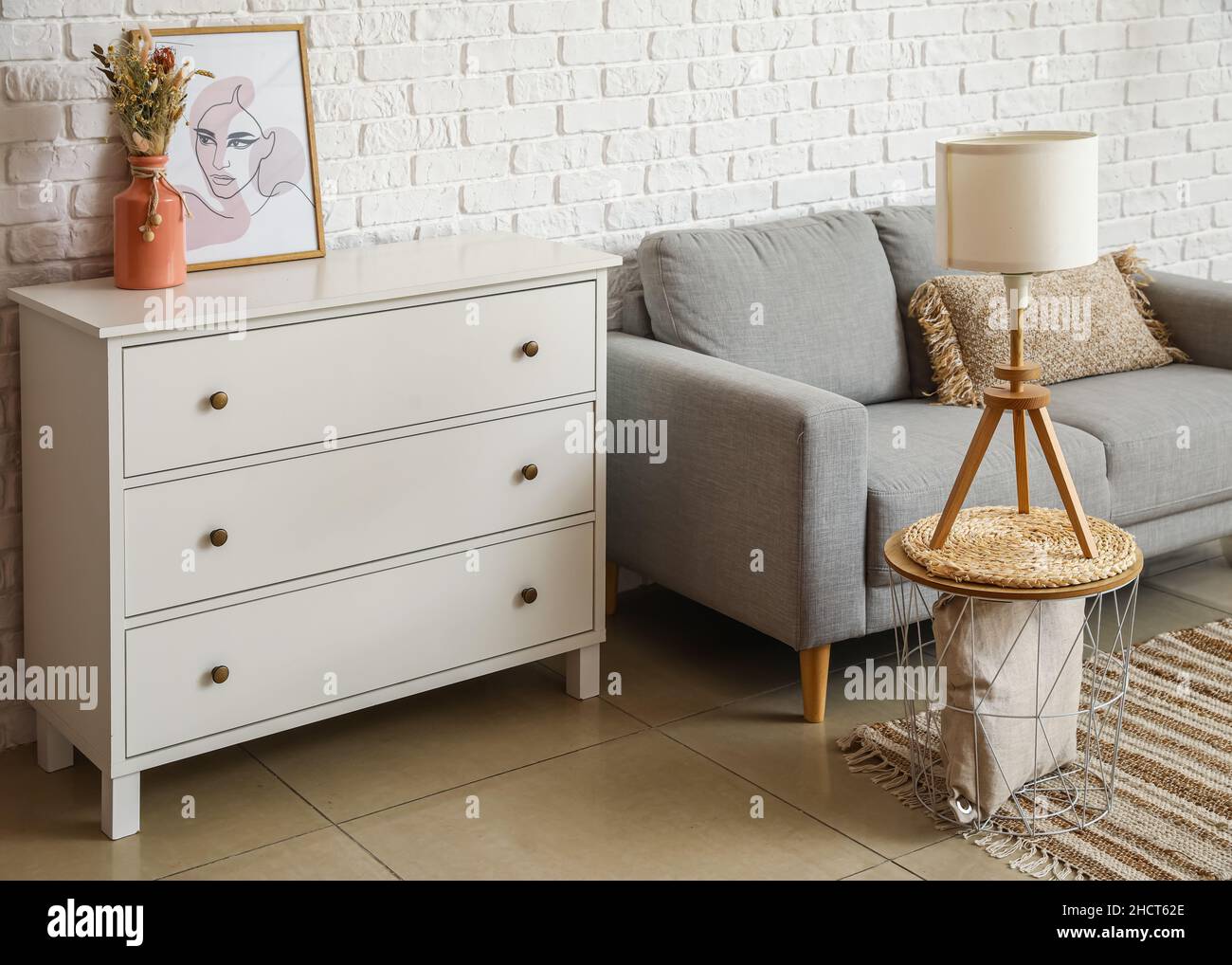 Interior of light living room with commode, lamp and coffee table Stock ...