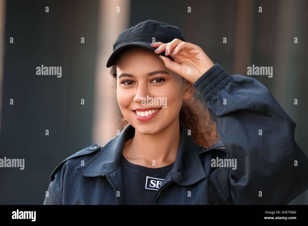 Smiling African-American female security guard outdoors, closeup Stock ...