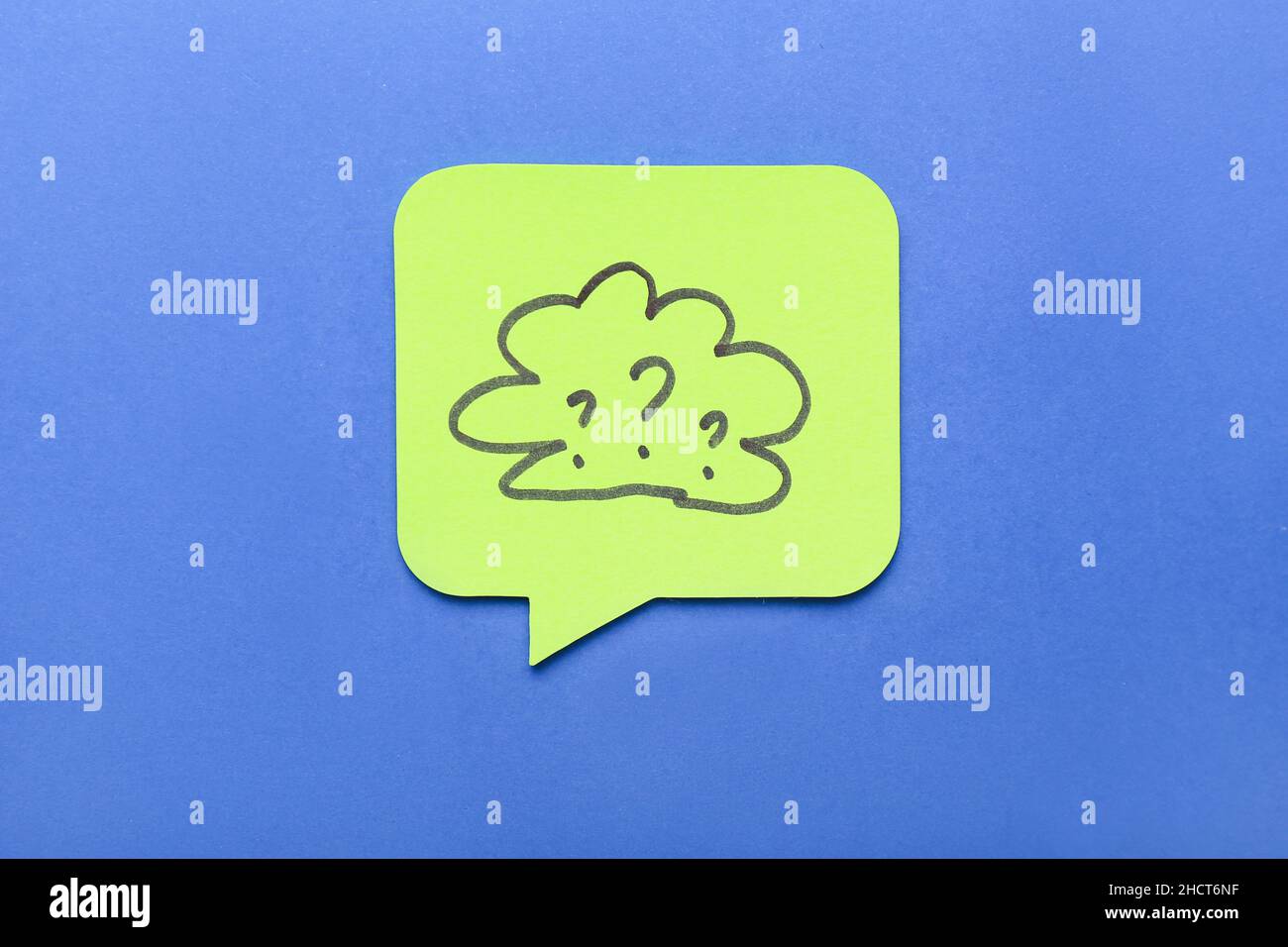 Sticky note with drawn cloud and question marks on blue background Stock Photo