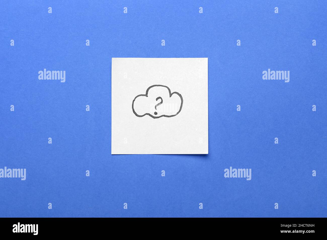 Sticky note with drawn cloud and question mark on blue background Stock Photo
