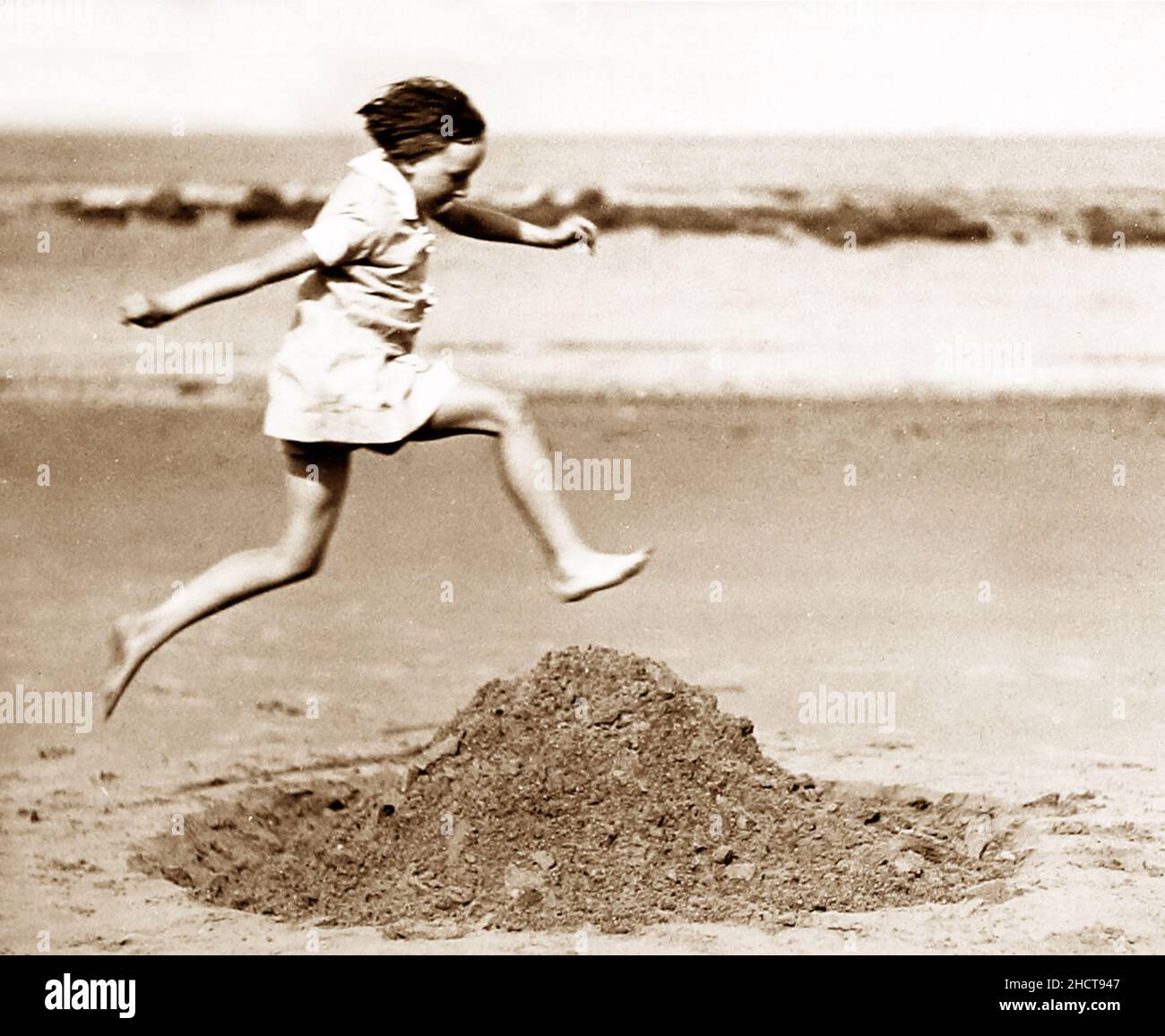 Girl playing on the beach, early 1900s Stock Photo