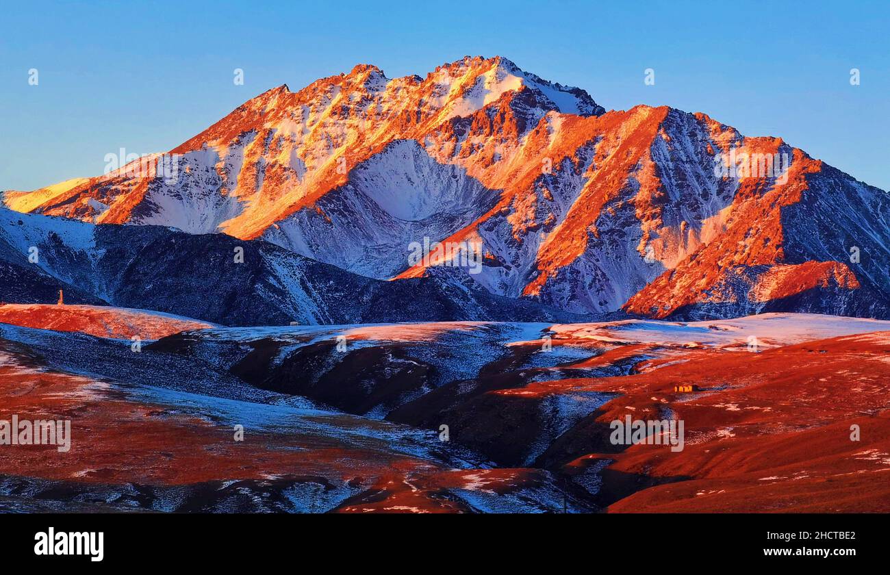 ZHANGYE, CHINA - JANUARY 1, 2022 - The first rays of 2022 sunshine spread over baars Snow Mountain in Zhangye City, Gansu Province, China, On January Stock Photo