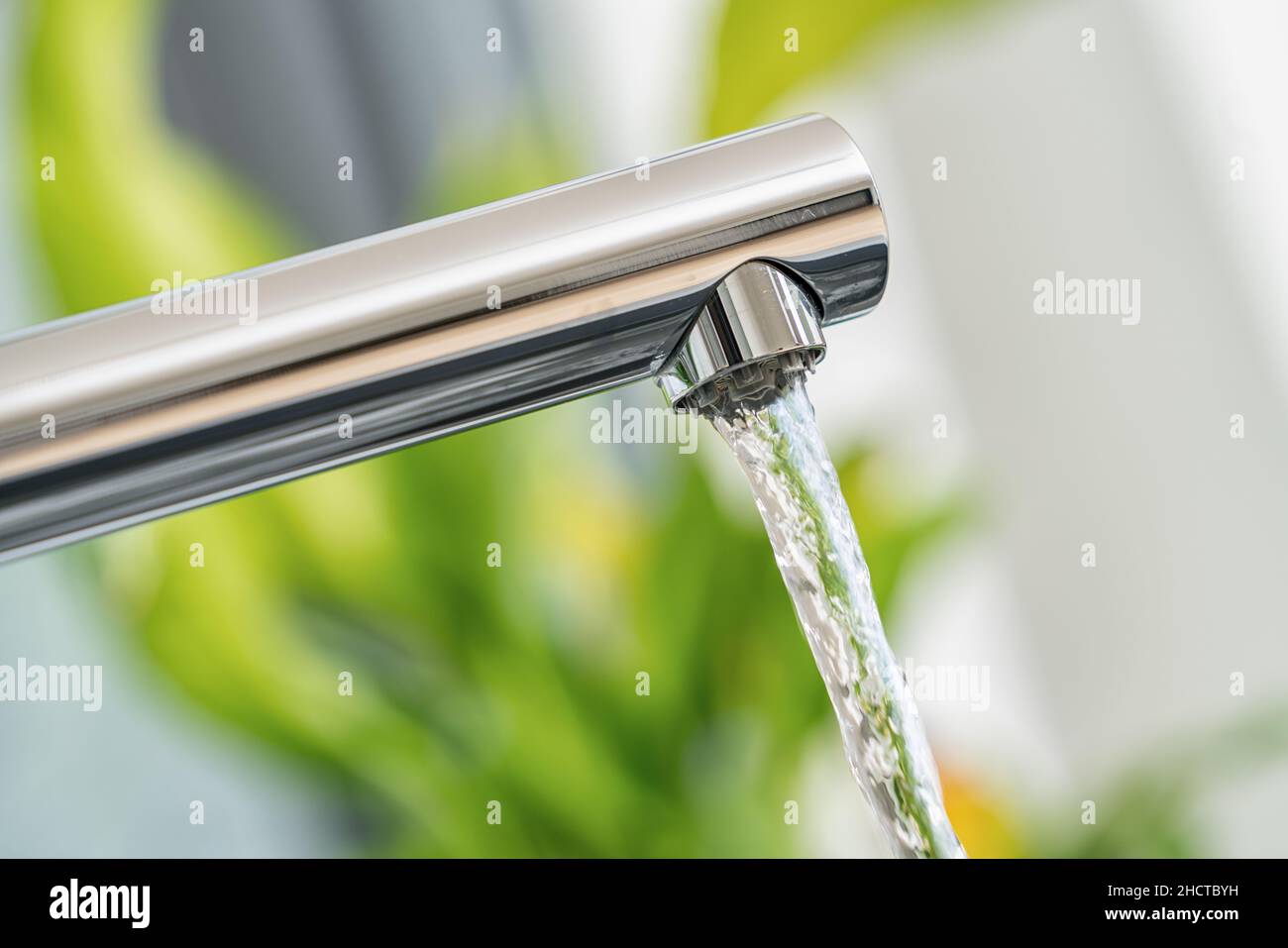 Open chrome faucet in the kitchen Stock Photo