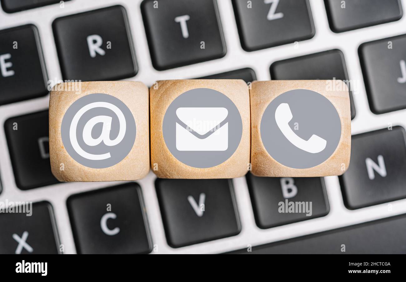 Wood cube symbol telephone, mail, address. Website page contact us or e-mail marketing concept Stock Photo