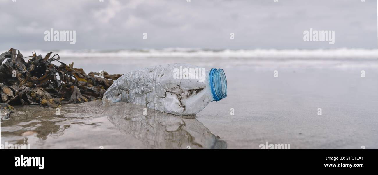 plastic bottle on the shore, copyspace for your individual text, banner size Stock Photo