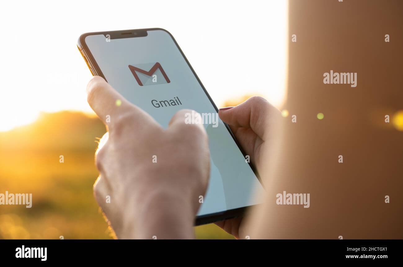 Business Woman Holding A IPhone With Google Gmail App Logo On The Display Gmail Is A Most 