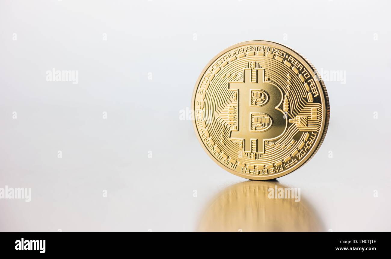 Single virtual cryptocurrency money Bitcoin golden coin on United Kingdom  Pound sterling banknotes with face of Adam Smith Stock Photo - Alamy