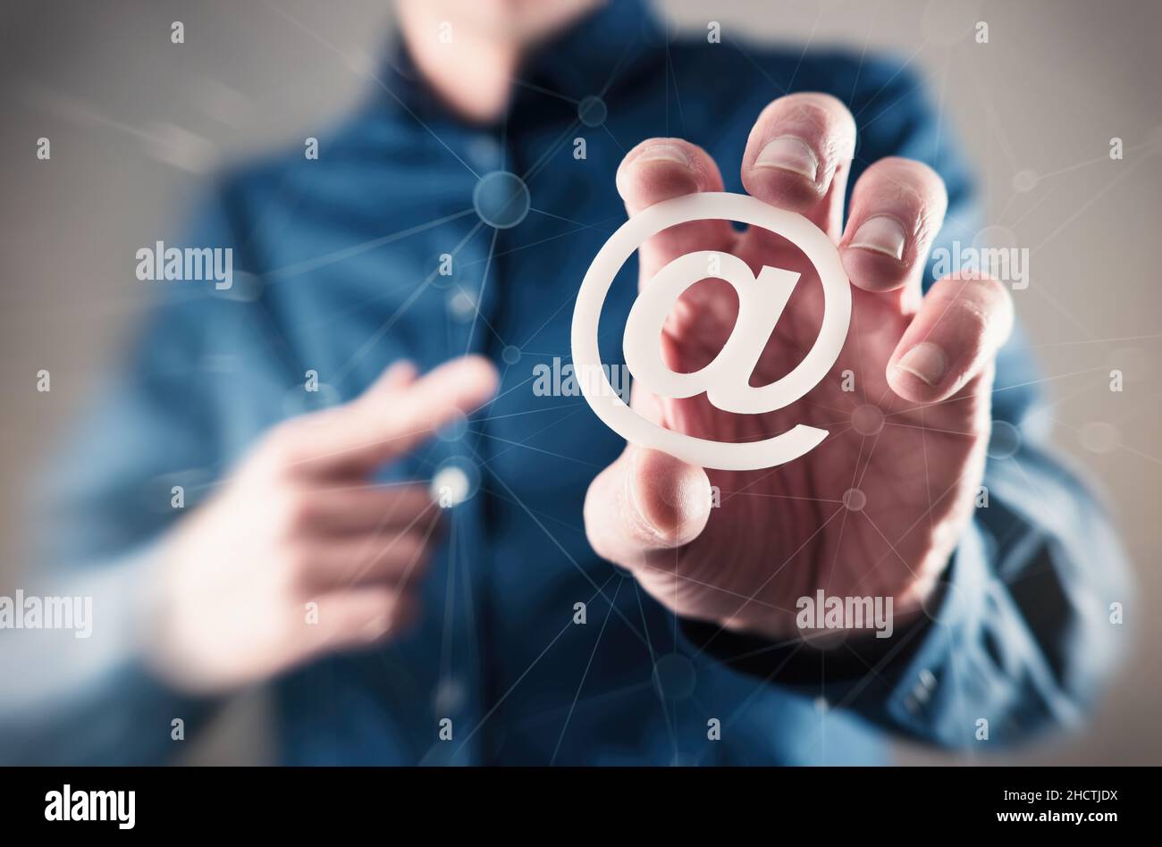 Email Example At Sign young business man holding email sign (at sign Stock Photo - Alamy