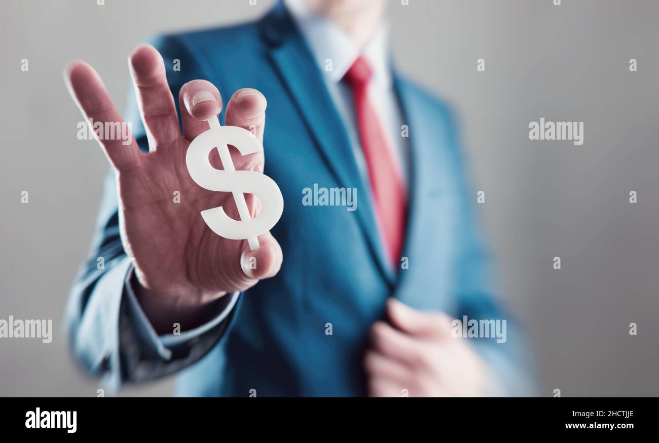 Businessman holding and presents a dollar sign Stock Photo - Alamy