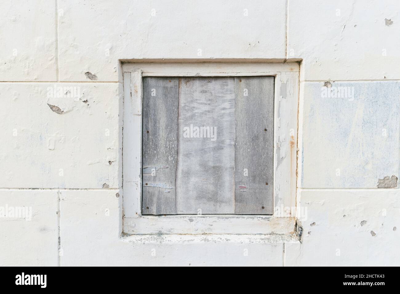 old weathered cement wall background with window Stock Photo