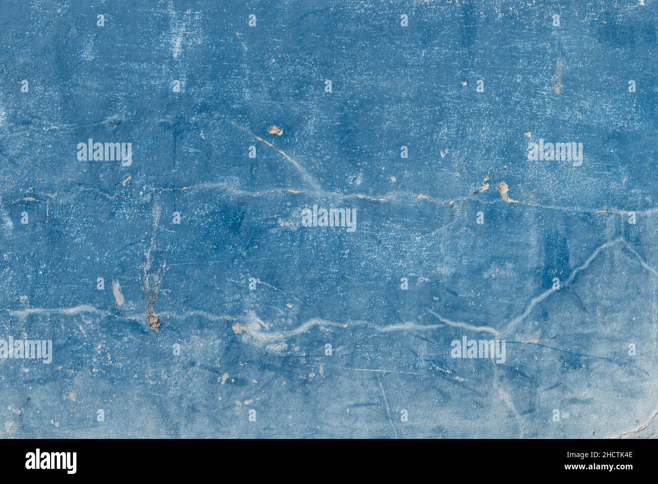 cracked blue concrete wall covered with  cement surface as background Stock Photo