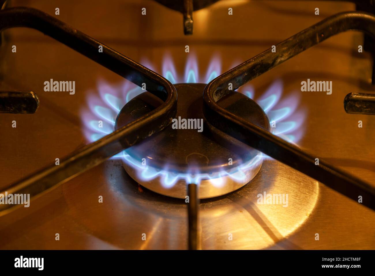 Gas burner cooker stove with a blue and red flame which is a non green