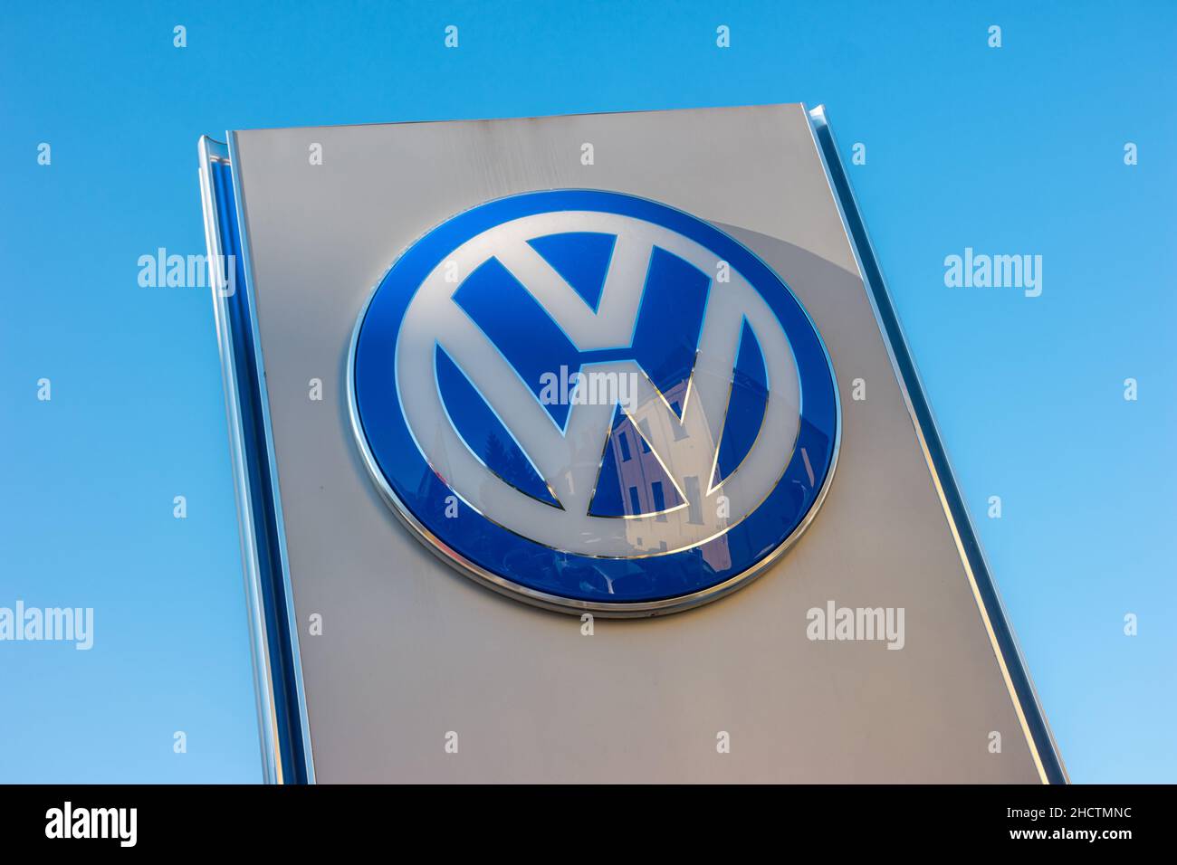 Volkswagen sign against blue sky. Volkswagen is the biggest German automaker and the third largest automaker in the world. Stock Photo