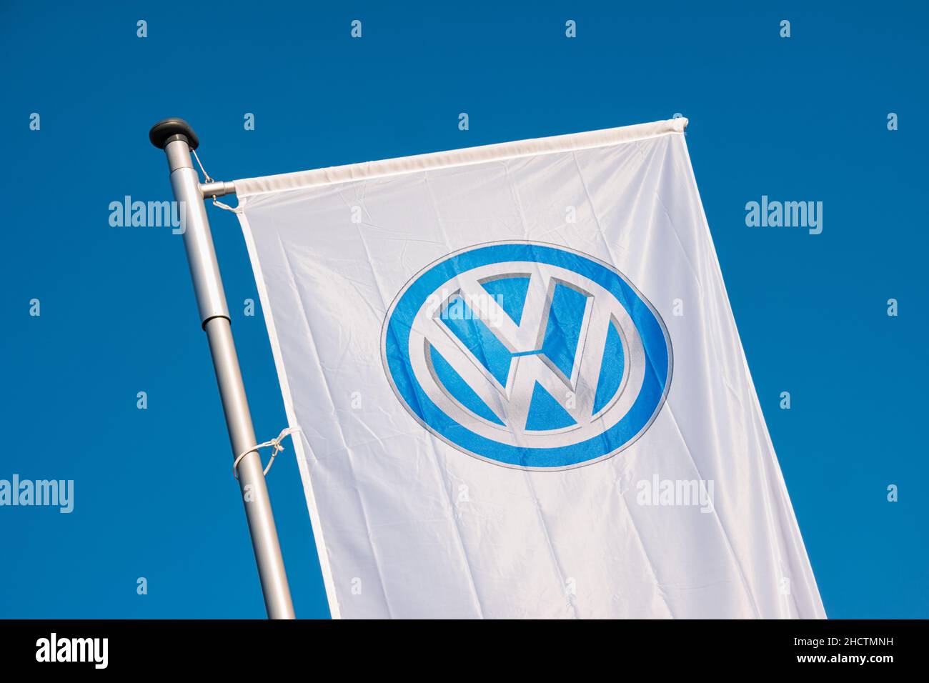Sign of a Volkswagen logo on a flag. Volkswagen is a German automobile manufacturer and the biggest German automaker and the third largest automaker i Stock Photo
