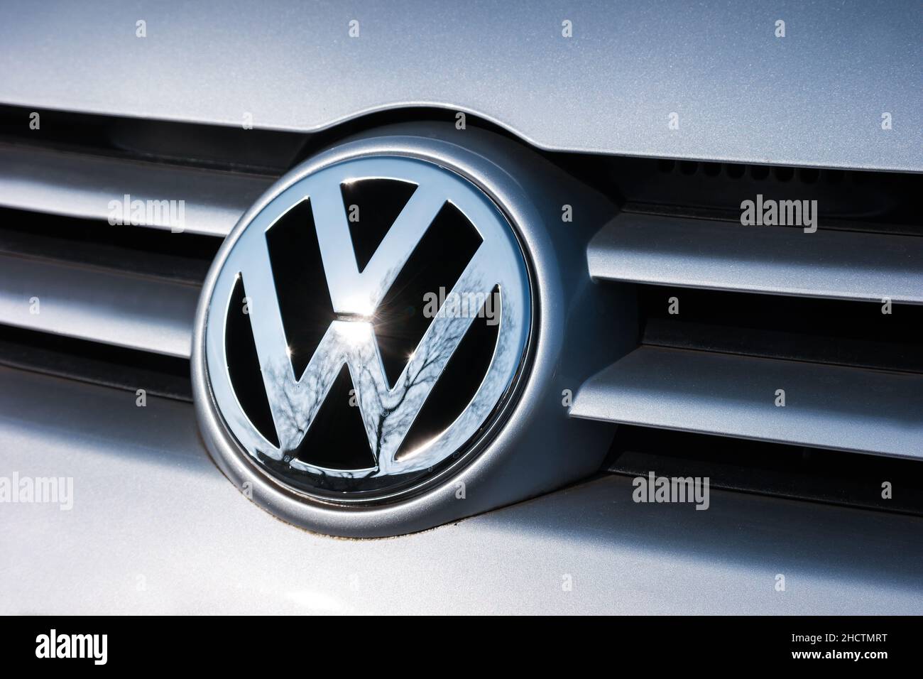 Volkswagen VW plate logo on a silver car. Volkswagen is a famous European car manufacturer company based on Germany. Stock Photo